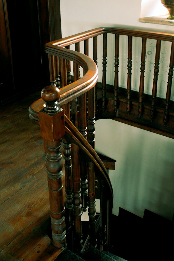 The Art of Drawing Readers In: Your attractive post title goes here Detailed view of a vintage wooden staircase with ornate railing indoors.