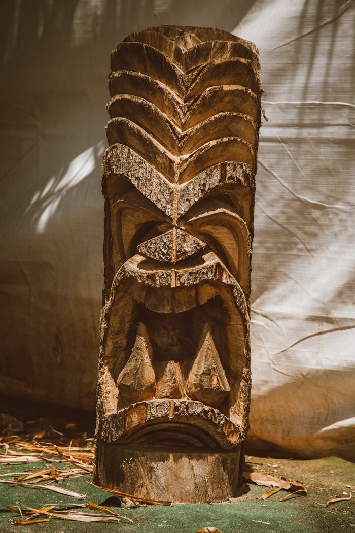 Close-up of a tiki sculpture made from wood, capturing the artistic details and cultural essence.