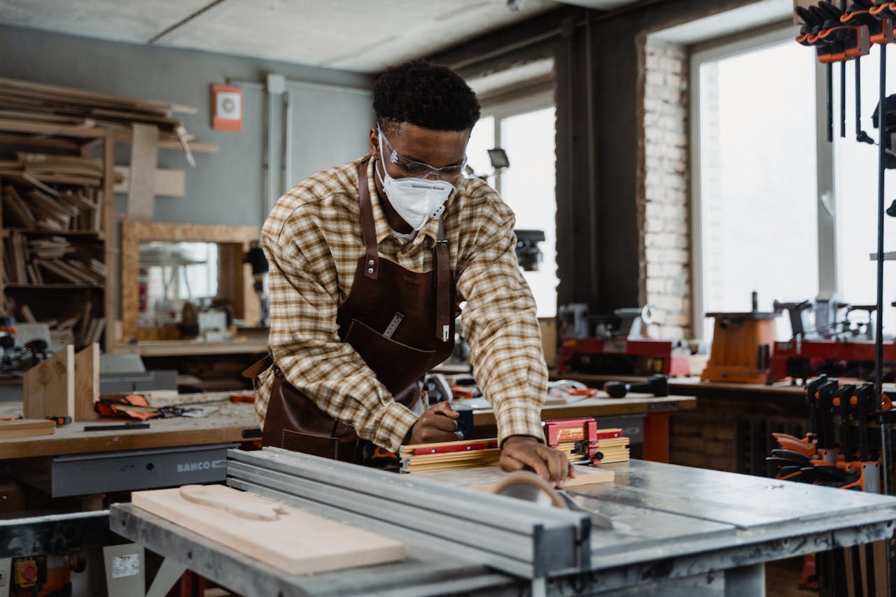 home-hero A focused craftsman demonstrating woodworking skills with tools in a workshop.